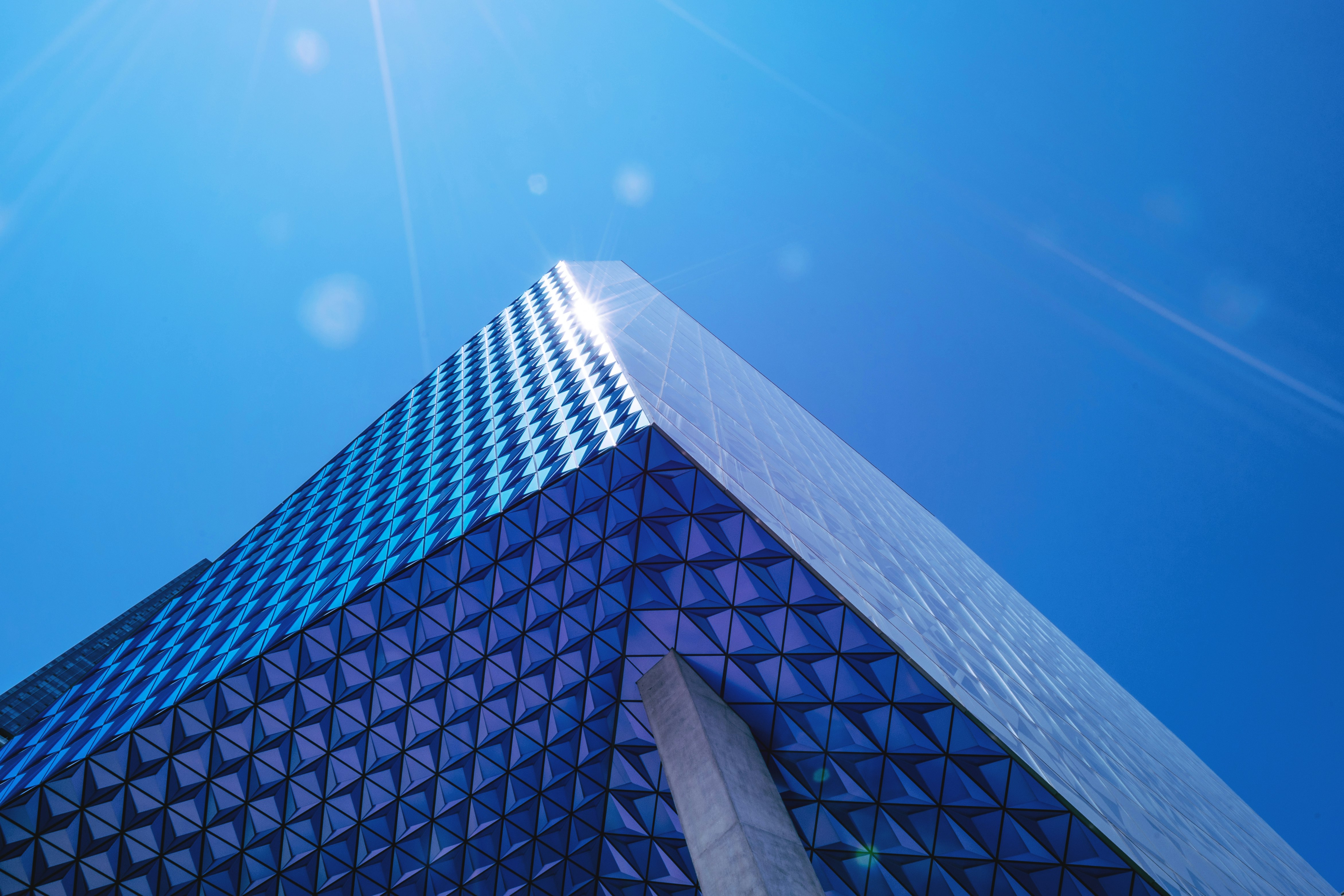 curtain-wall high rise building under blue sky